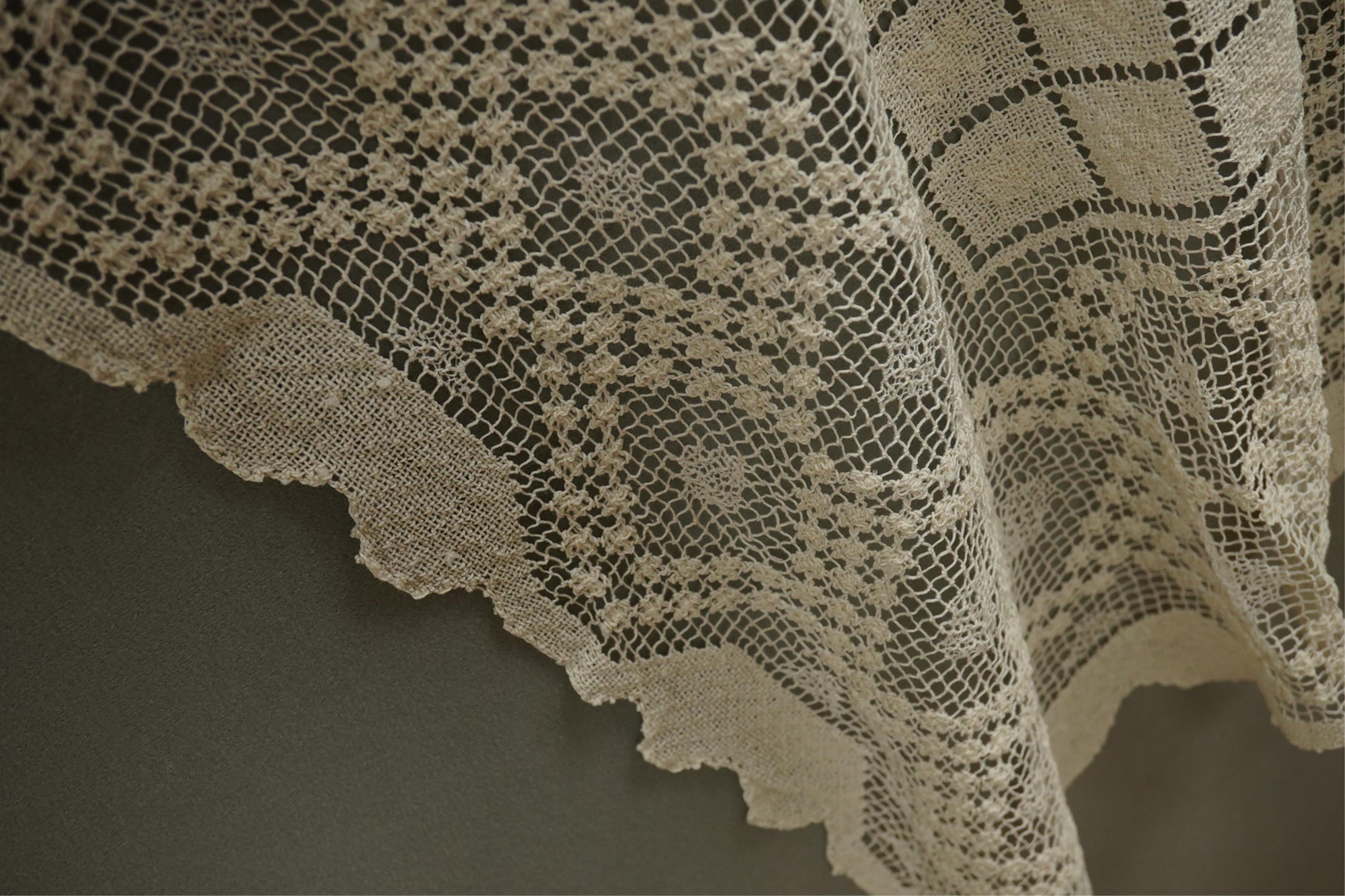 A collection of early 20th century and later crochet, cut work and drawn thread table linens and a large embroidered table cloth